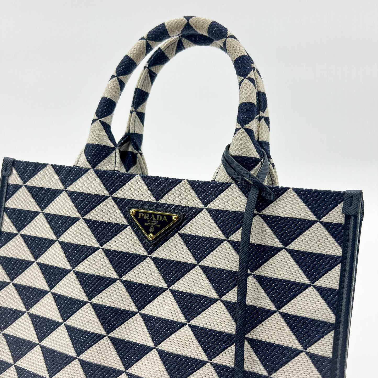 Prada symbol embroidered fabric tote bag